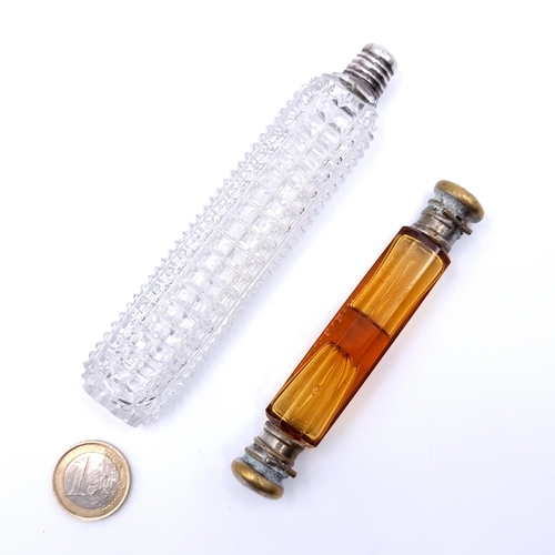 27 - Two fine examples of antique perfume bottles. The first example features hob nail cut detailing and ... 