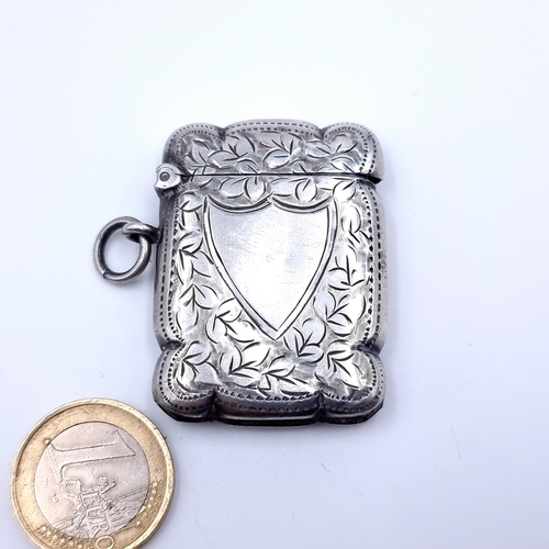 35 - An attractive antique sterling silver Vesta case, with ring holder feature and a shield and foliate ... 