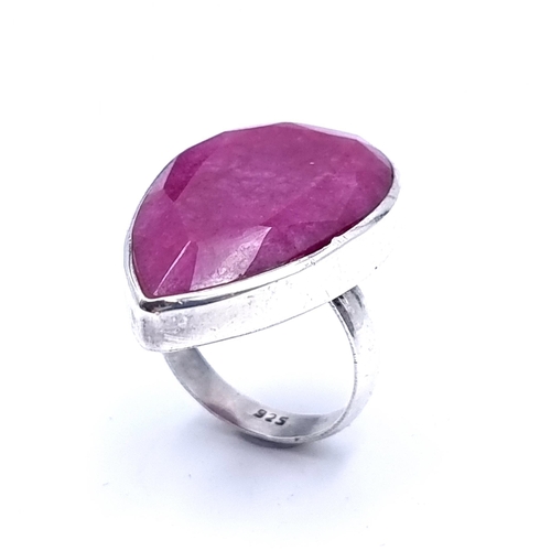 47 - A stunning sterling silver ring, with an impressive Facet cut pear shaped centre Indian Ruby. Ring s... 