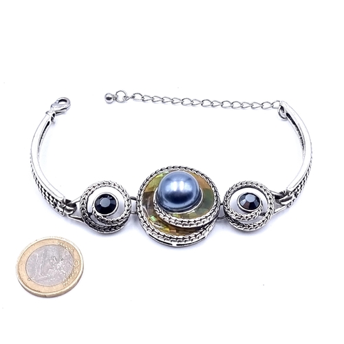 48 - A fine example of a swirl abstract design Pearl and stone set bracelet, with a beautiful iridescent ... 