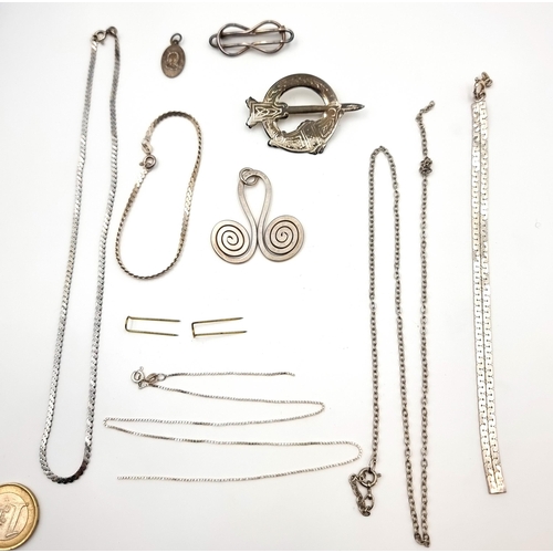 A collection of silver items, consisting of silver chains, bracelets, a Celtic brooch and pendant. All encased in a purple vintage jewellery case. Some items need attention. Total weight: 39.6 grams.