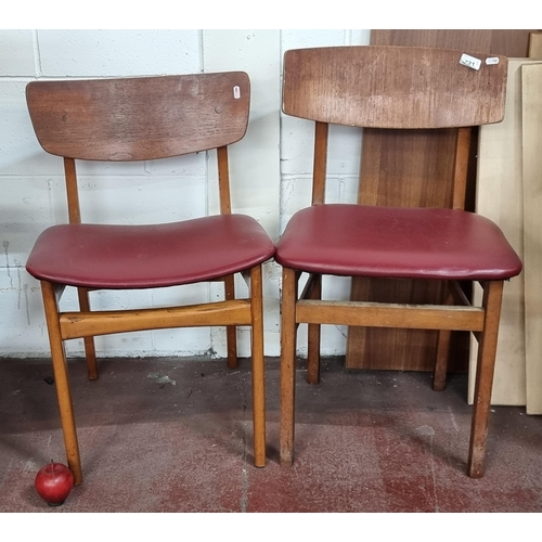 721 - A pair of handsome, Mid Century teak dining chairs. With clean simple lines and cherry red vinyl sea... 