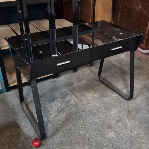 728 - A chic contemporary desk with tempered glass top, two drawers and metal legs all finished in black.