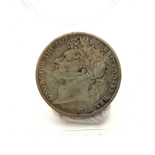 11 - A George IV silver half crown, circa 1823. Together with a 1819 George III silver shilling. Both in ... 