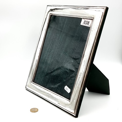 38 - A very fine example of a very large Irish silver photo frame, by C. F Limited. Internal dimensions: ... 