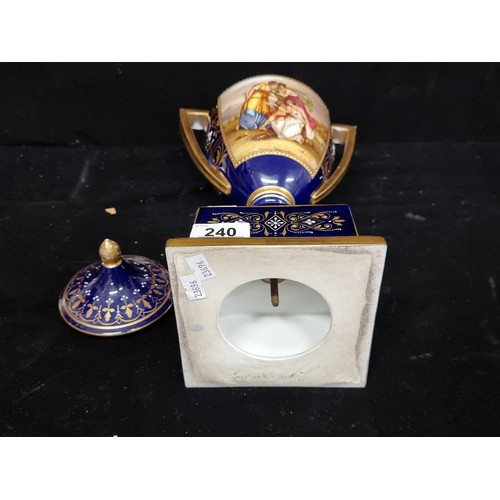 240 - A beautiful high quality porcelain Vienna style urn with lid, with hand painted decoration on a brig... 