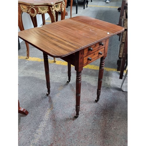 392 - Star Lot : A lovely, neatly proportioned drop leaf table on castors, with four drawers and turned le... 