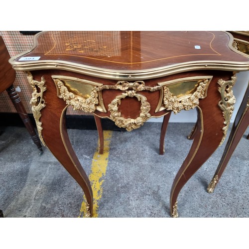 395 - Star Lot : A superb Louis XV style side table. With a pie crust top and sleek sabre legs, this piece... 