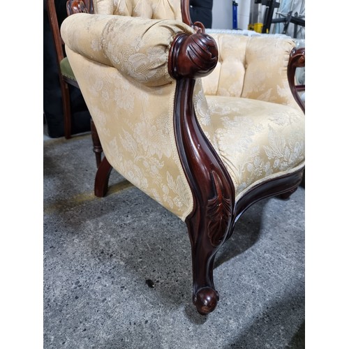 470 - A beautiful Victorian style armchair with lovely curves throughout the carved wooden frame. Upholste... 