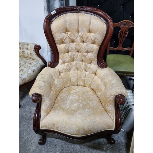 470 - A beautiful Victorian style armchair with lovely curves throughout the carved wooden frame. Upholste... 