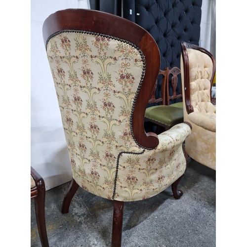 469 - A beautiful Victorian style armchair with lovely curves throughout the carved mahogany frame. Uphols... 