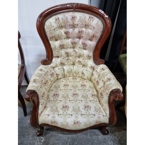 469 - A beautiful Victorian style armchair with lovely curves throughout the carved mahogany frame. Uphols... 