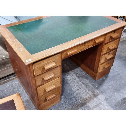 458 - A great 1930s example of a golden oak pedestal desk with green leather inlay and furnished with nine... 