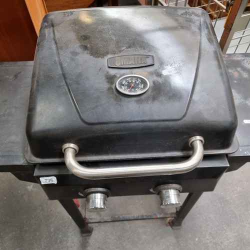 736 - An Omaha made gas powered barbeque with temperature gauge to lid and preparation space to each side.