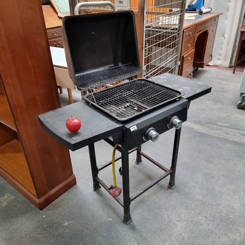 736 - An Omaha made gas powered barbeque with temperature gauge to lid and preparation space to each side.