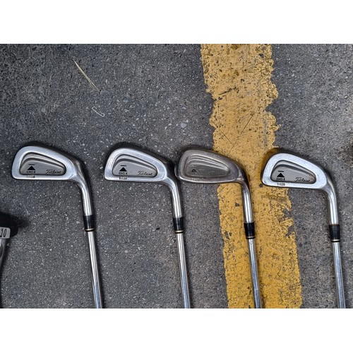 316 - A Powacaddy golf bag with nine golfing irons (3, 4, 5, 6, 7, 9, P) made by Titleist, along with a Go... 