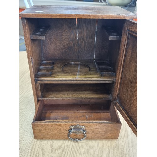 592 - A fabulous Edwardian oak smoker's compendium with inlay cartouche. In great condition.