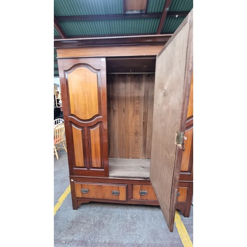 630 - A fantastic large Edwardian wardrobe with recessed panelled detailing, three cupboards, two drawers ... 