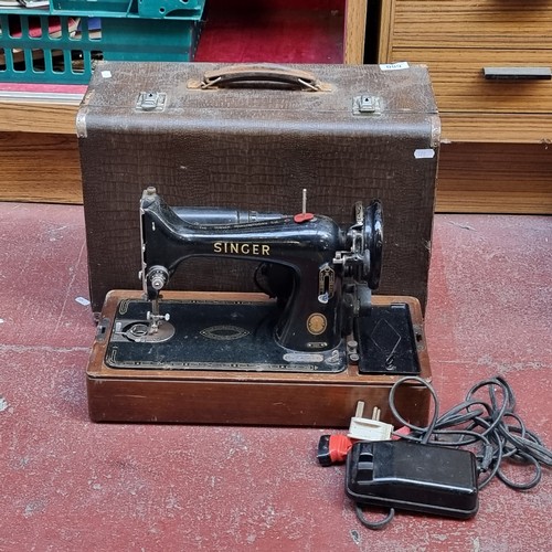 680 - An antique Victorian portable Singer sewing machine model 99K complete with footpedal and three pin ... 