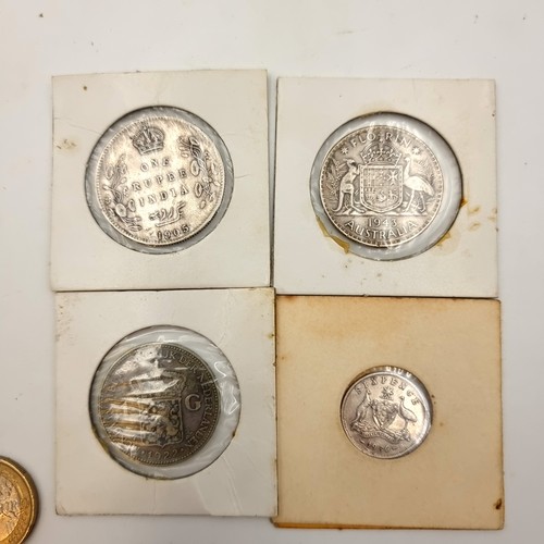 22 - A collection of four silver coins, including an 1905 Indian Rupee, A Queen Wilhelmina coin and two A... 