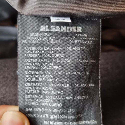 323 - A stunning designer coat by Jill Sander, finished in an angora wool blend in a rich, deep brown shad... 