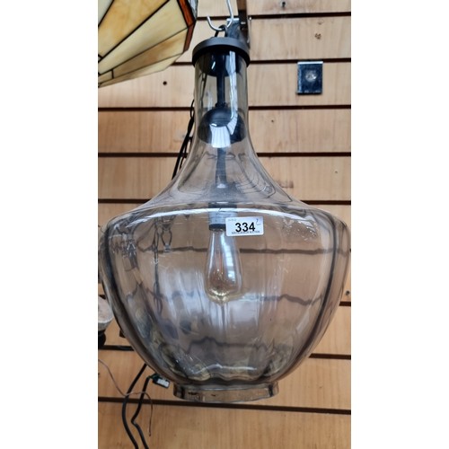 334 - A stunning pair of smoke tinted pendant lights. With a subtly ribbed glass exterior and matte black ... 