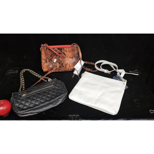 181 - Three handbags including a genuine white leather handbag by Marks and Spencer's. Brand new with tags... 