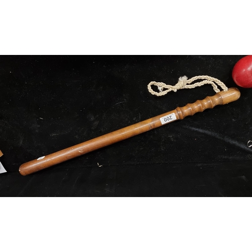 200 - A vintage very long wooden truncheon with rope handles. In good condition.