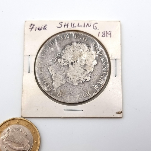 23 - A George III five shilling silver coin, circa 1819. Weight: 28.35 grams.