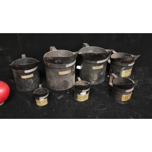 238 - A full set of7  Victorian measuring jugs with lead stamps and brass measuring plates to the front. A... 