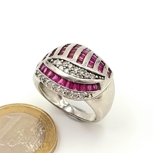 40 - A vintage sterling silver ring, with a stunning channel cut Ruby and gem setting. Size: Q. Weight: 7... 