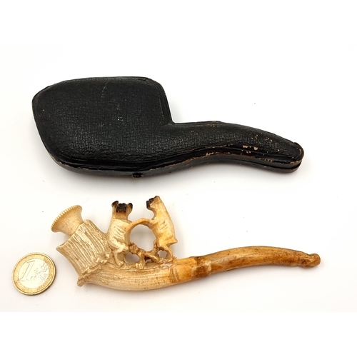 41 - A genuine antique Mersham pipe, this example is fantastically carved with a dog motif. Presented in ... 