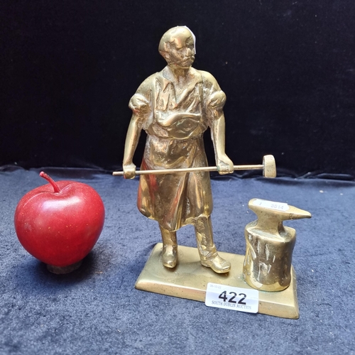 422 - A very heavy solid brass sculpture of a blacksmith at work with his anvil.