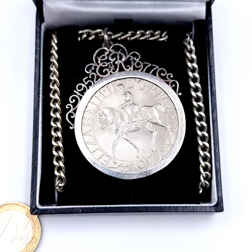 548 - A 25th anniversary coronation mounted medallion for the late Queen Elizabeth II, with beautiful scro... 