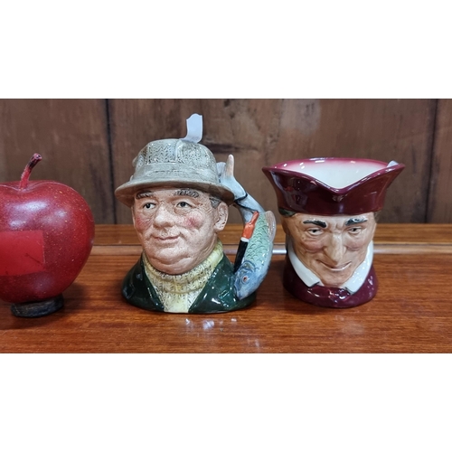 562 - A pair of vintage Toby jugs by Royal Doulton, one of which is labelled 'The Angler' and the other de... 