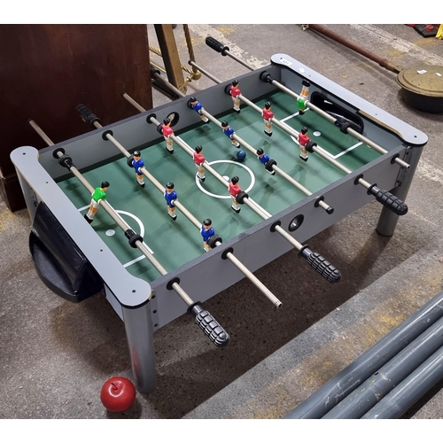 621 - A freestanding Foosball (Football) table. With players in red and blue jerseys. A ball is included. ... 