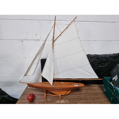 625 - A large  handsome hand crafted model of a sail boat with a wooden hull and masts, with cotton sails ... 