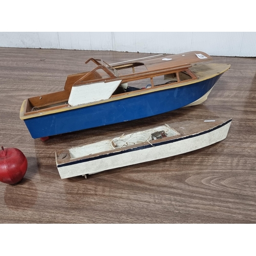 627 - Two vintage remote control boats, including a speedboat and a smaller rowing boat. Both with partial... 