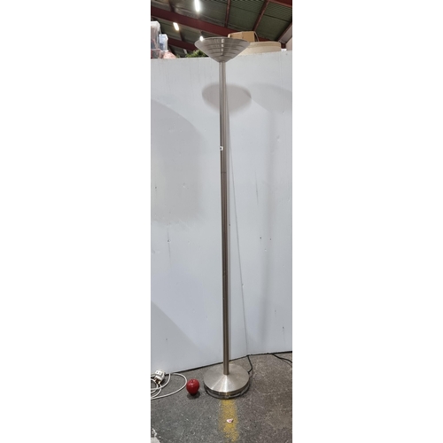 684 - A very tall sleek floor standing lamp with upturned shade in a brushed chrome finish.