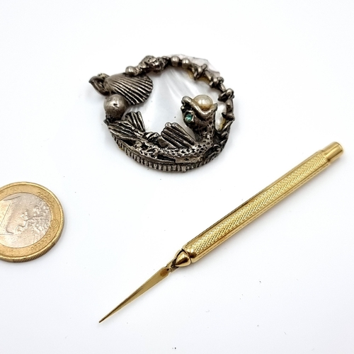 7 - Two items, including a very nice example of a sterling silver pendant with shell and fish detail and... 