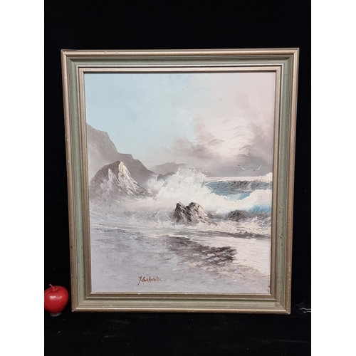 71 - An original oil on board painting of waves crashing against a rocky shore signed bottom left. Housed... 