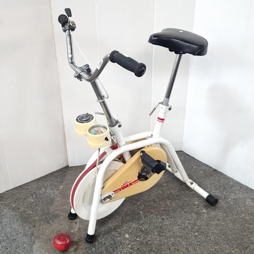 A vintage stationary bike by York gym equipment brand. A heavy steel ...