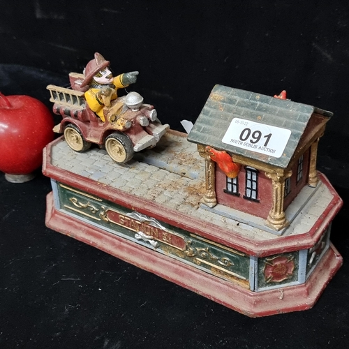91 - A remarkably heavy cast metal money box in the form of a fire truck with fire fighter, on a rescue m... 