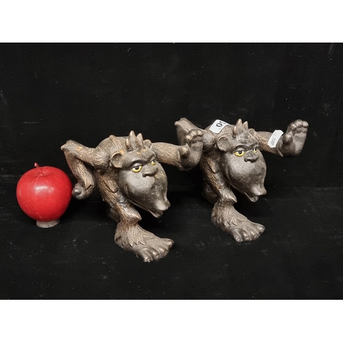 94 - A pair of very heavy, cast metal book ends in the form of mischievous trolls. A fun pair with great ... 