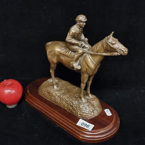 96 - An impressive brushed metal sculpture of a jockey on a racehorse, mounted on a wooden base. With gre... 