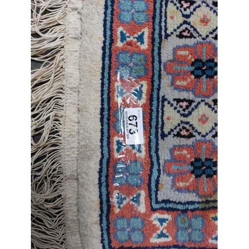 673 - Star Lot : A lovely large hand made and hand knotted low pile 100% wool floor rug with geometric des... 