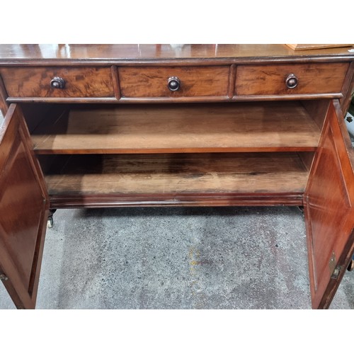 599 - Star Lot : A magnificent Victorian, flamed mahogany sideboard on castors . With large cupboard stora... 