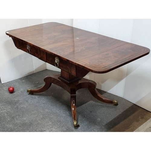 663 - Star Lot : An amazing large George IV tiger flame mahogany sofa table with drop leaf, quadroped pill... 