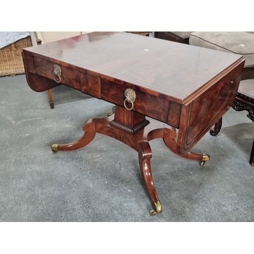 663 - Star Lot : An amazing large George IV tiger flame mahogany sofa table with drop leaf, quadroped pill... 