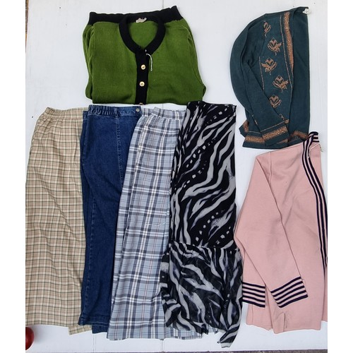 419 - A selection of seven genuine vintage items, including a tailored skirt in a pale tartan check, an A-... 